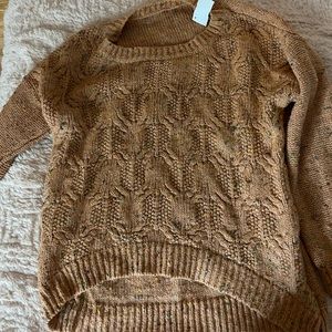 Knitted sweater. Not itchy. Very cute with leggings and boots